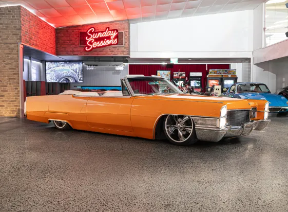 Orange classic convertible in the Sunday Drive showroom